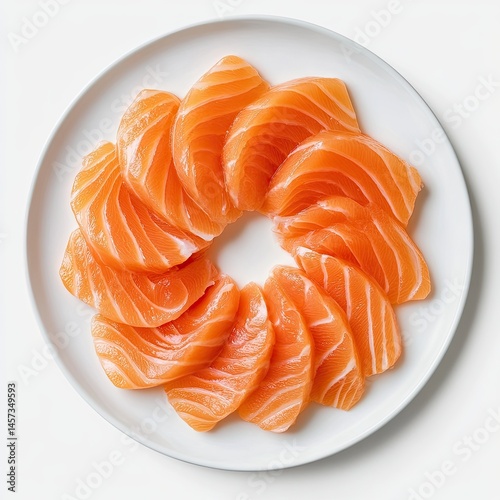 Fresh salmon sashimi slices arranged in a circle on a plate photo