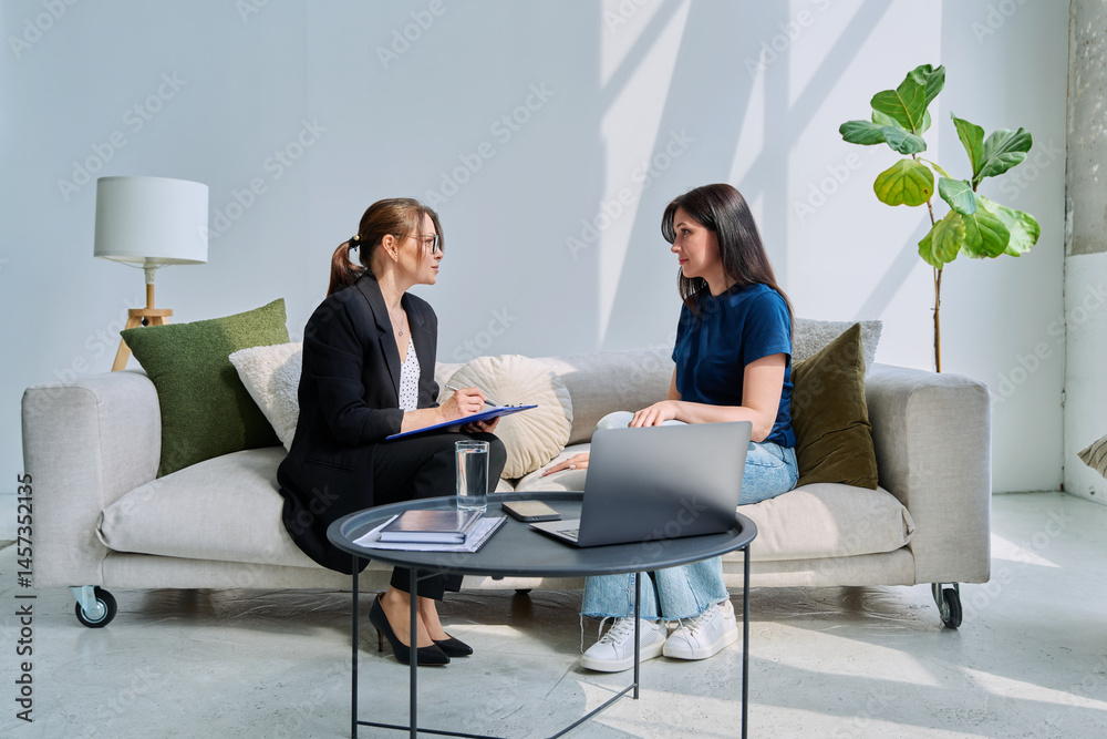 Young woman patient at mental therapy session, talking with psychologist