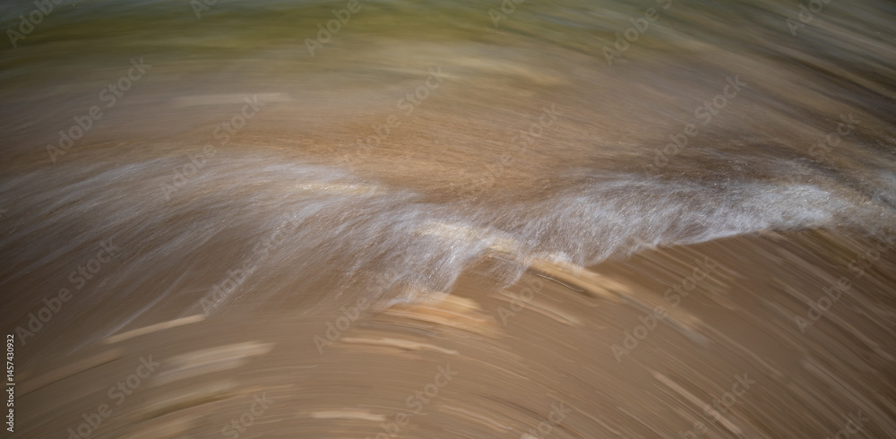Motion of Blurred ocean waves on shore. Nature abstract background