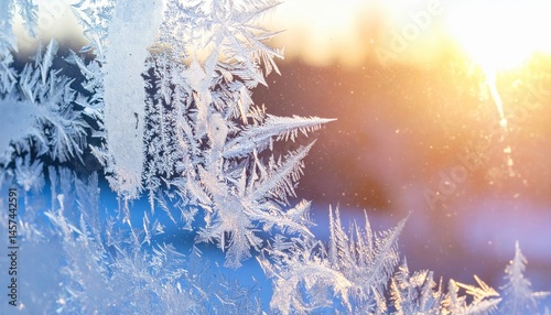 Frost patterns delicately form intricate designs on a windowpane, evoking a serene winter mood against a softly blurred, colorful background.