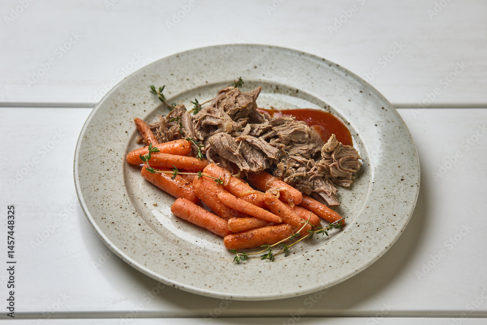 Pulled pork with glazed carrots and herbs