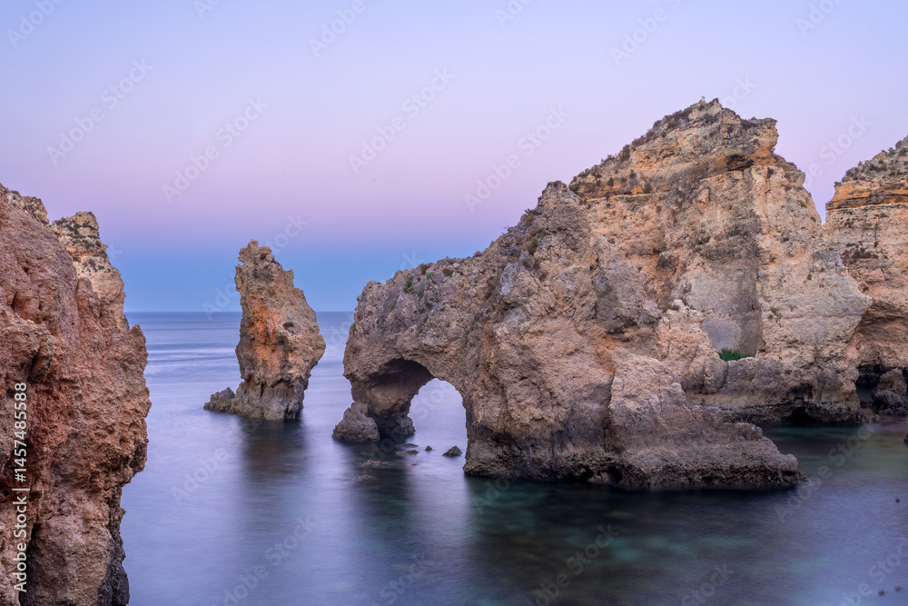Fototapeta premium Punta da Piedade cliffs in the Algarve region of Portugal at dusk.