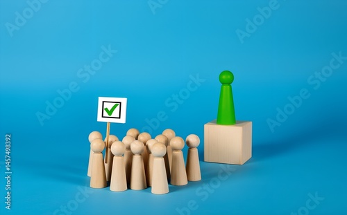 Wooden Figures: A group of wooden figures represent the electorate listening to a green wooden figure on a cube, indicating a concept about power, voting or decisions.