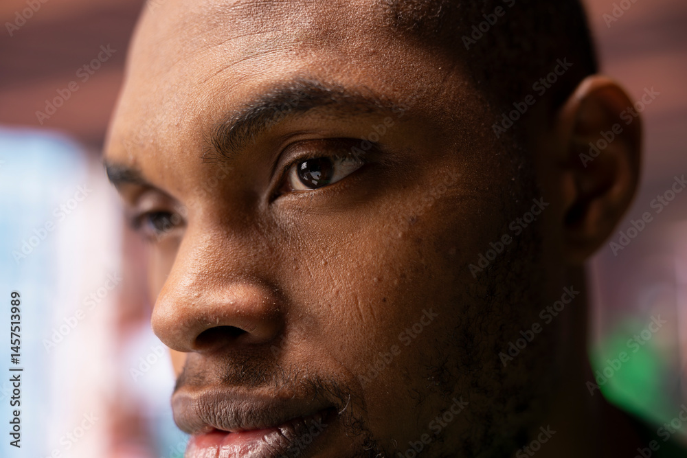 Obraz premium Focus on man eyes with pensive reflective look doing ruminating in apartment. African american person with focused expression lost in deep thoughts, extreme close up shot