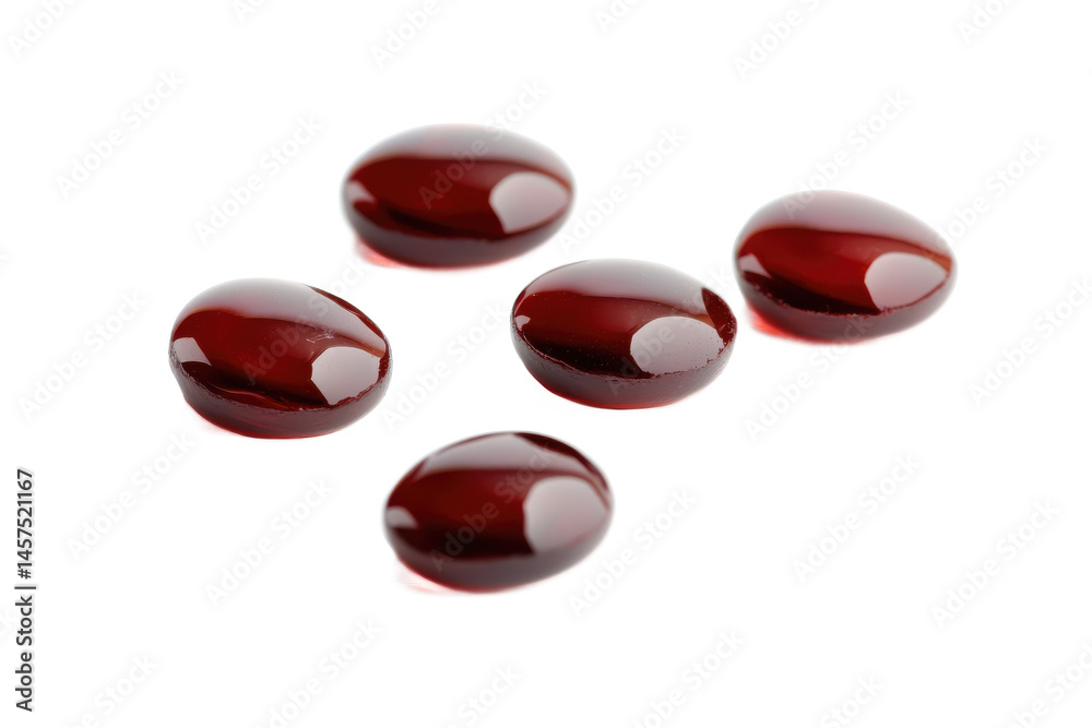 A group of five red capsules arranged on a black background with a mosaic effect around them shown A group of five red capsules arranged on a black background with a mosaic effect around them shown