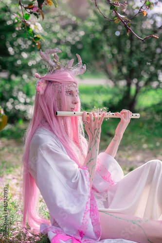 Принти на полотні Deer dryad girl against the background of a blooming pink apple tree