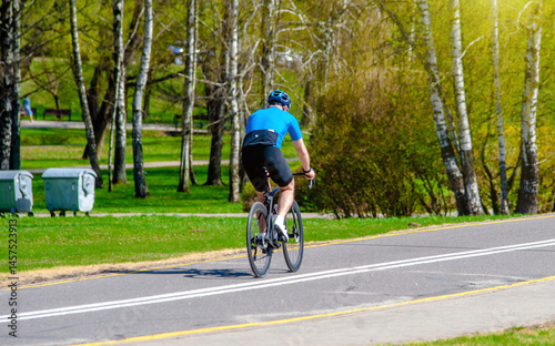 Wallpaper Mural Cyclist ride on the bike path in the city Park
 Torontodigital.ca
