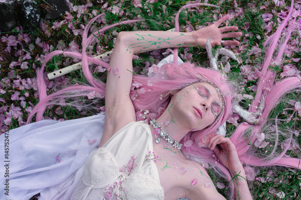 Deer dryad girl against the background of a blooming pink apple tree
