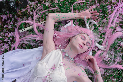 Obraz na płótnie Deer dryad girl against the background of a blooming pink apple tree w salonie