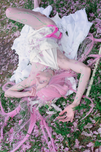Obraz na płótnie Deer dryad girl against the background of a blooming pink apple tree w salonie