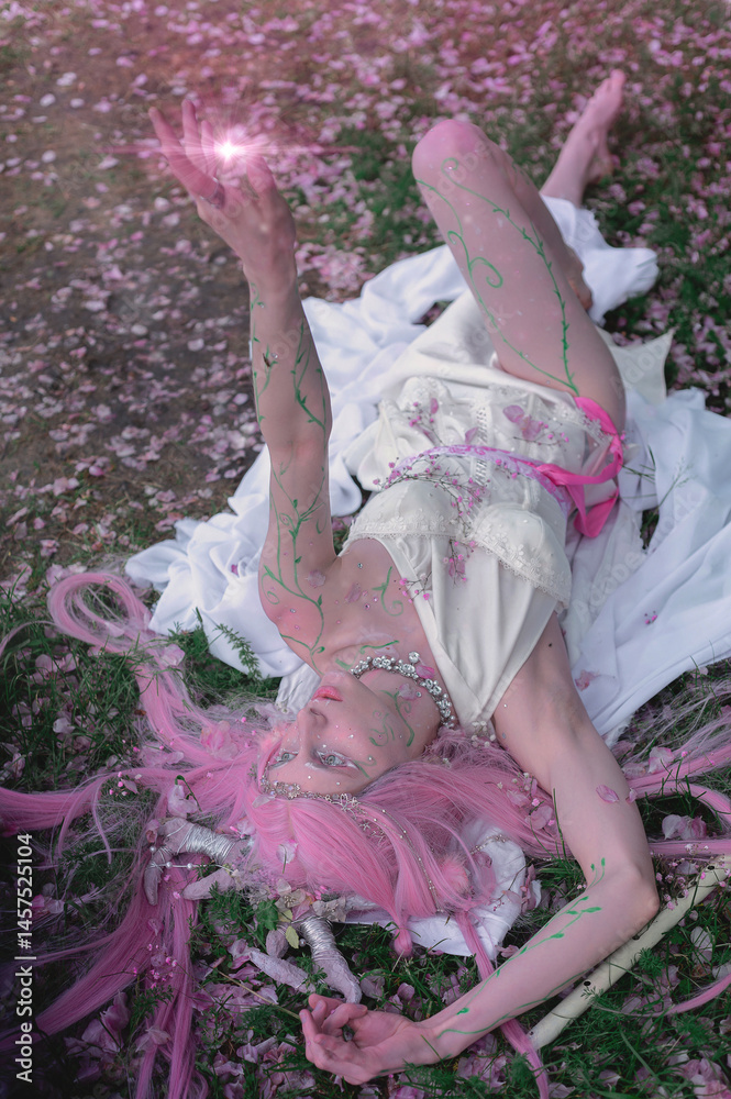 Deer dryad girl against the background of a blooming pink apple tree