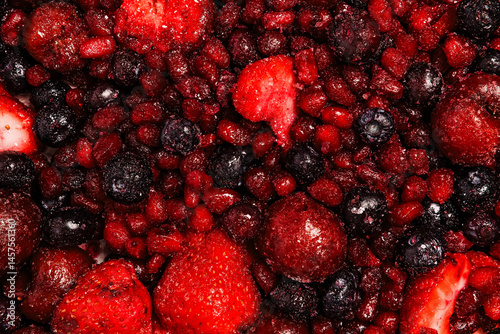 Various frozen mixed red berries close-up