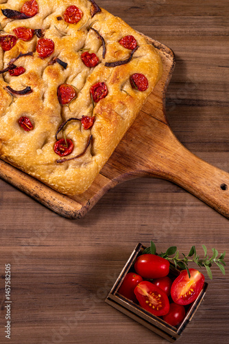 Traditional Italian Focaccia with cherry tomatoes, black olives and rosemary.