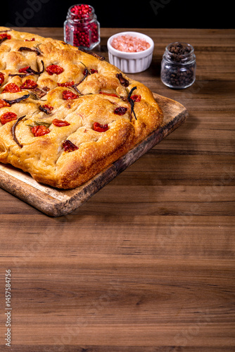 Traditional Italian Focaccia with cherry tomatoes, black olives and rosemary.