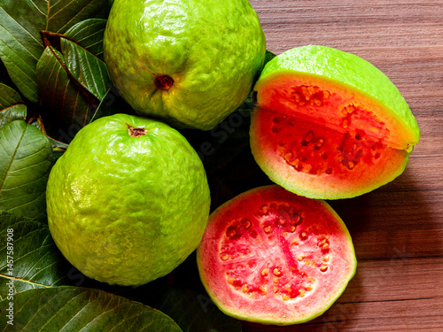 Beautiful fresh red guava, autumn fruit on wooden rustic background.