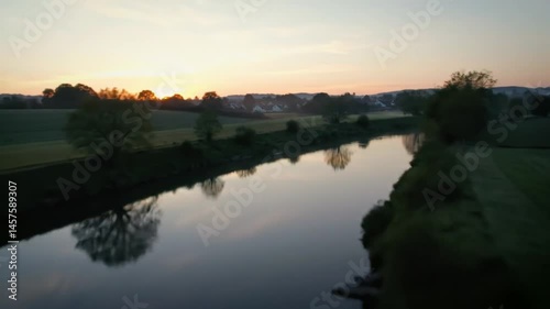 Drone View of a Serene River Landscape at Sunrise