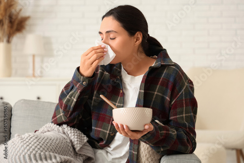 Sick young woman with tissu...