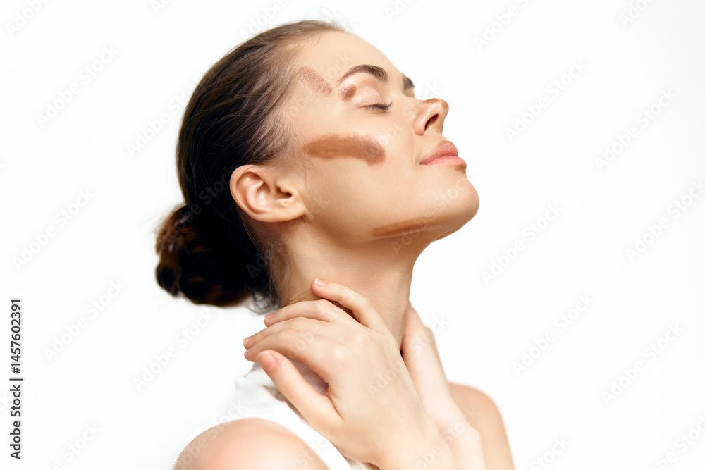 Young woman with artistic makeup showcasing beauty and creativity against a clean white background, expressing confidence and serenity through her pose and expression.