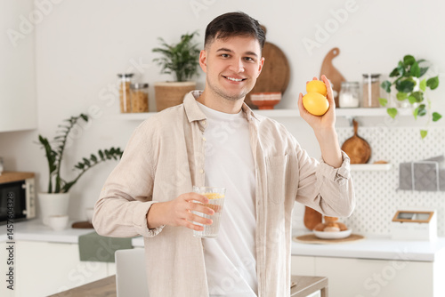 Young man with glass of wat...