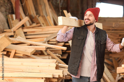 Young carpenter with wooden...