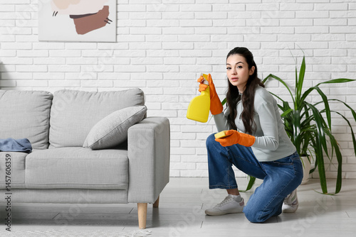 Young woman with spray bott...