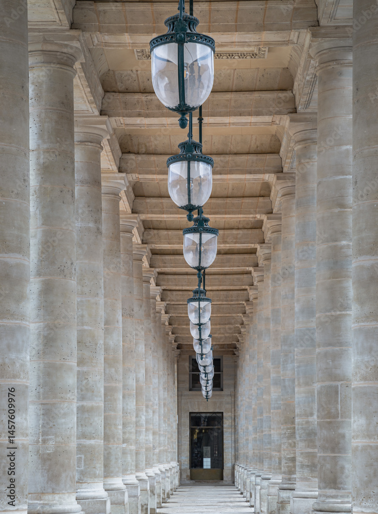 Corridor perspective with Columns and Antique lantern hanging from Ceiling inside of the Courtyard of the Honor gallery in the National estate of the Palais-Royal. use it as your Wallpaper, Poster.