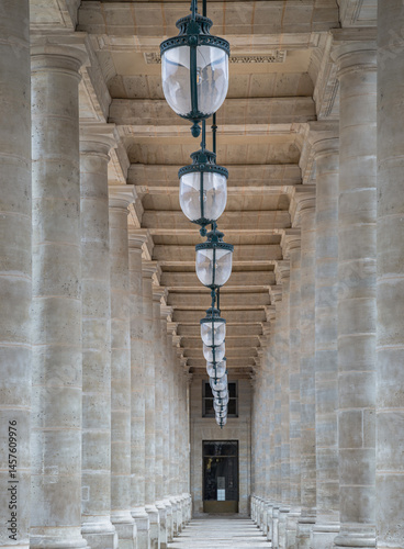 Obraz na płótnie Corridor perspective with Columns and Antique lantern hanging from Ceiling inside of the Courtyard of the Honor gallery in the National estate of the Palais-Royal. use it as your Wallpaper, Poster. w salonie