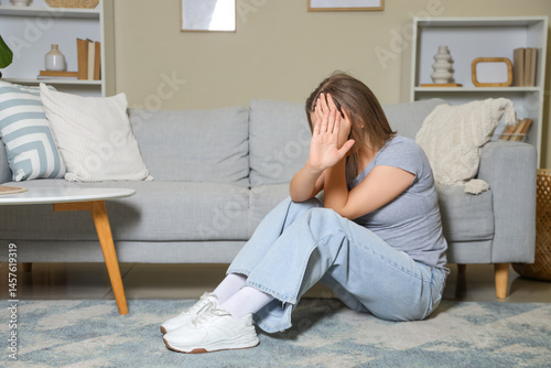 Young woman showing stop ge...