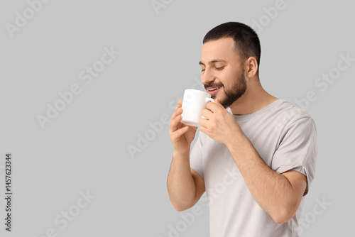 Handsome young man drinking...
