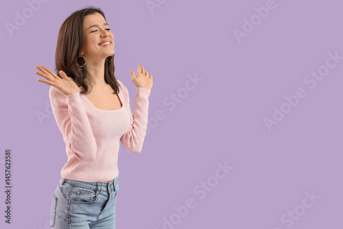 Young woman on lilac backgr...