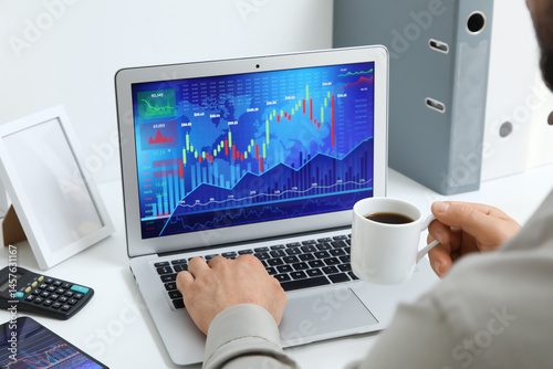 Male trader with coffee cup...