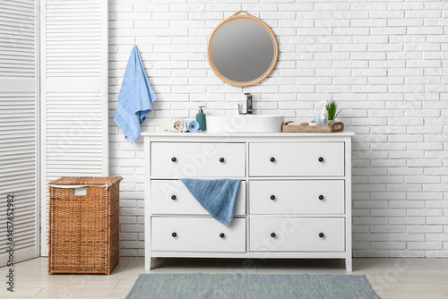 Φωτογραφία Interior of stylish bathroom with sink, dresser and folding screen