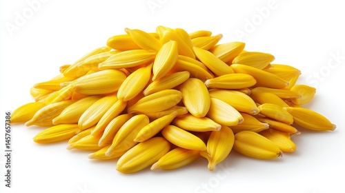 A pile of yellow, elongated seeds with ridged surfaces sits on a white background.