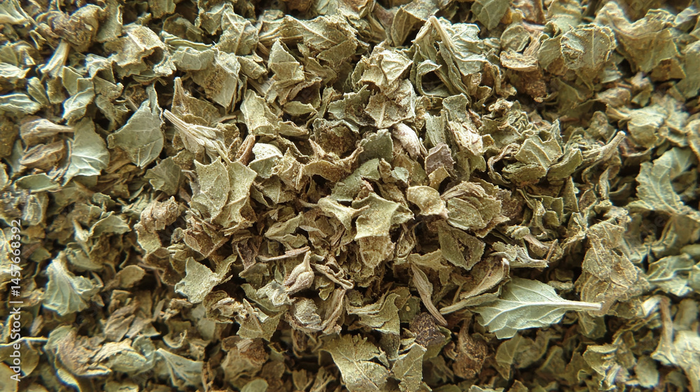 Top view of a textured pile of dried and chopped basil spice, symbolizing natural flavor, culinary tradition, and the essence of Mediterranean cooking in organic, earthy tones.