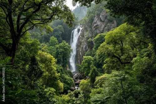 Majestic waterfall cascading through lush green forest foliage.