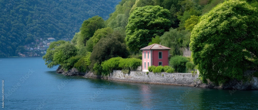 Scenic view of a red house by a tranquil lake surrounded by greenery.