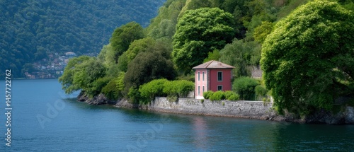 Obraz na płótnie Scenic view of a red house by a tranquil lake surrounded by greenery. w salonie