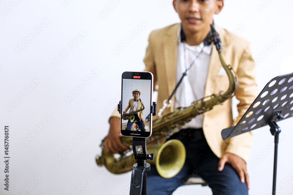 Naklejka premium Happy Vlog Musician Man Blogger Using Smartphone Talking On Video Streaming