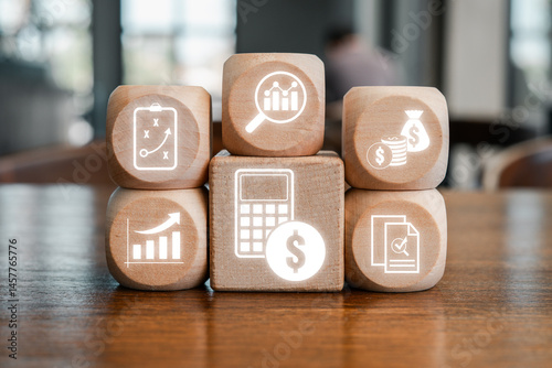 Wooden blocks with financial and analytical icons representing the concept of calculation and business strategy.