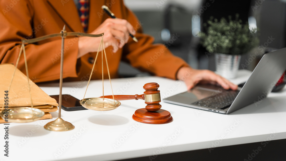 An elderly Caucasian male lawyer works at his desk in a law firm, offering legal advice and business law services. A gavel and documents symbolize justice and professionalism