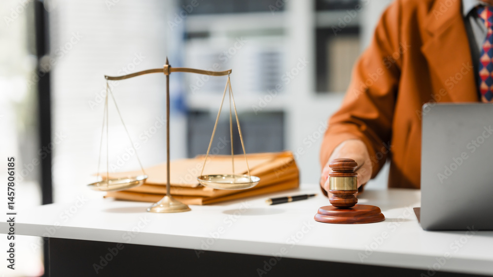 An elderly Caucasian male lawyer works at his desk in a law firm, offering legal advice and business law services. A gavel and documents symbolize justice and professionalism
