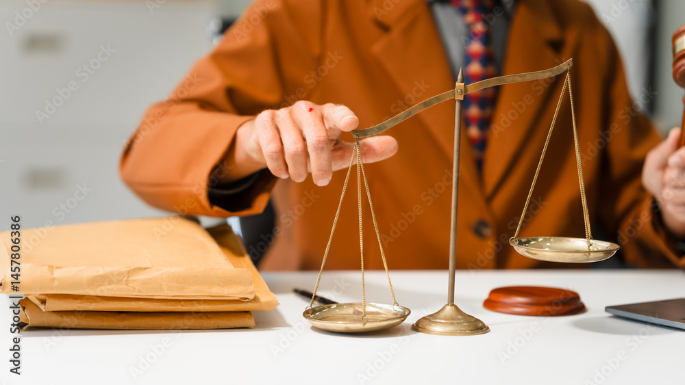 An elderly Caucasian male lawyer works at his desk in a law firm, offering legal advice and business law services. A gavel and documents symbolize justice and professionalism