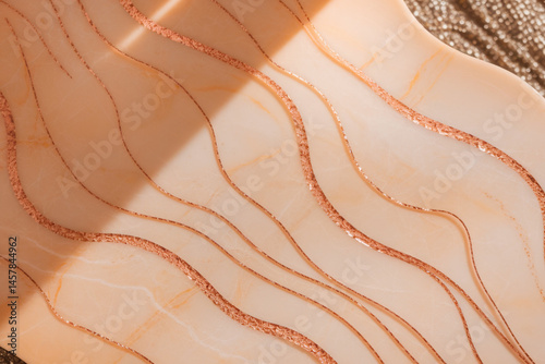 A piece of art with a gold and white color scheme