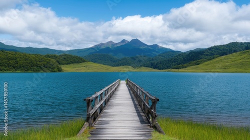 Serene Lake View with Wooden Dock and Mountain Landscape Under Clouds