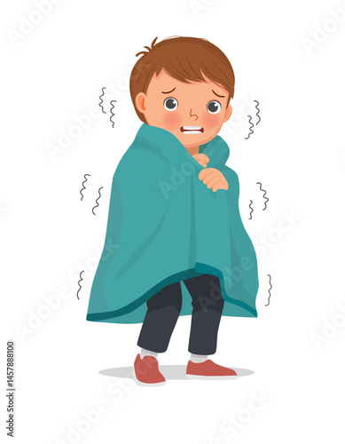 Little boy trembling and shivering feeling cold covered with blanket