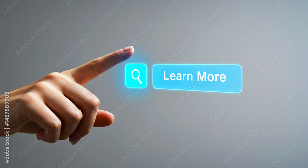 A hand pointing towards a glowing learn more button with a search icon on a gray background image A hand pointing towards a glowing learn more button with a search icon on a gray background image