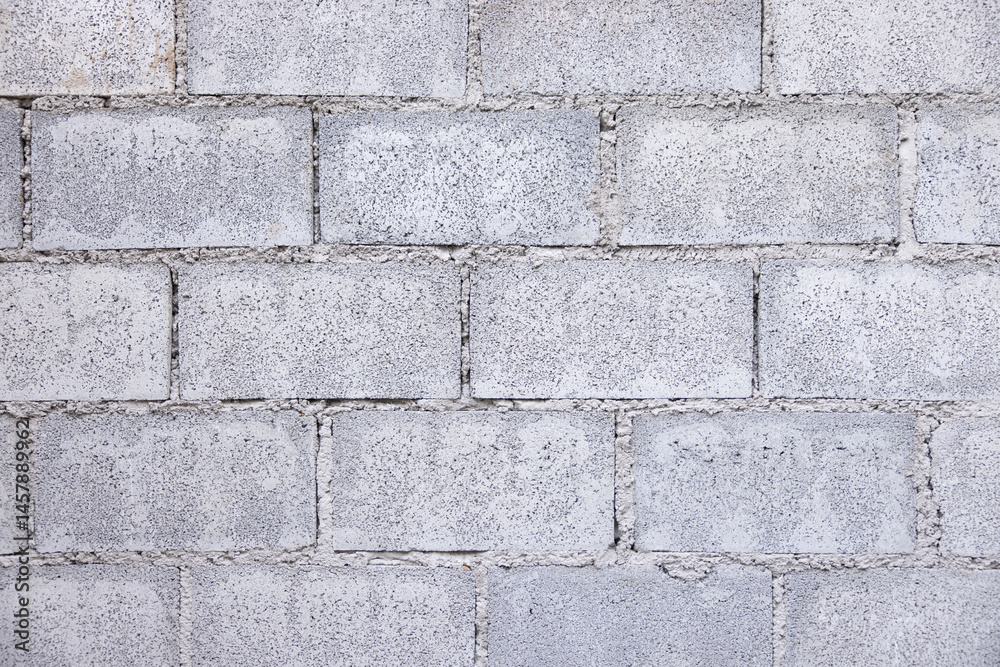 Concrete block wall background wide and horizontal composition consist of rough surface texture cement and gravel. Pattern of rectangle shape masonry in stacked row in construction building work. Concrete block wall background wide and horizontal composition consist of rough surface texture cement and gravel. Pattern of rectangle shape masonry in stacked row in construction building work.