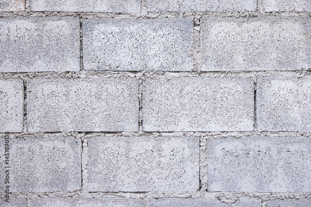 Concrete block wall background consist of rough surface of texture cement and gravel. Pattern of rectangle shape masonry in stacked row horizontal in construction building work. Suit for background. Concrete block wall background consist of rough surface of texture cement and gravel. Pattern of rectangle shape masonry in stacked row horizontal in construction building work. Suit for background.
