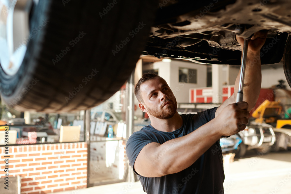 Fototapeta premium Maintenance, mechanic and tools for car service in workshop for repair and inspection. Roadworthy, handyman and working on vehicle in garage for performance, transportation and test tire for safety