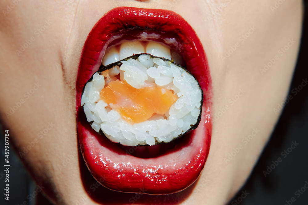 Close-up of a woman's mouth with sushi, featuring red lipstick and a playful expression, emphasizing food culture and culinary delight.